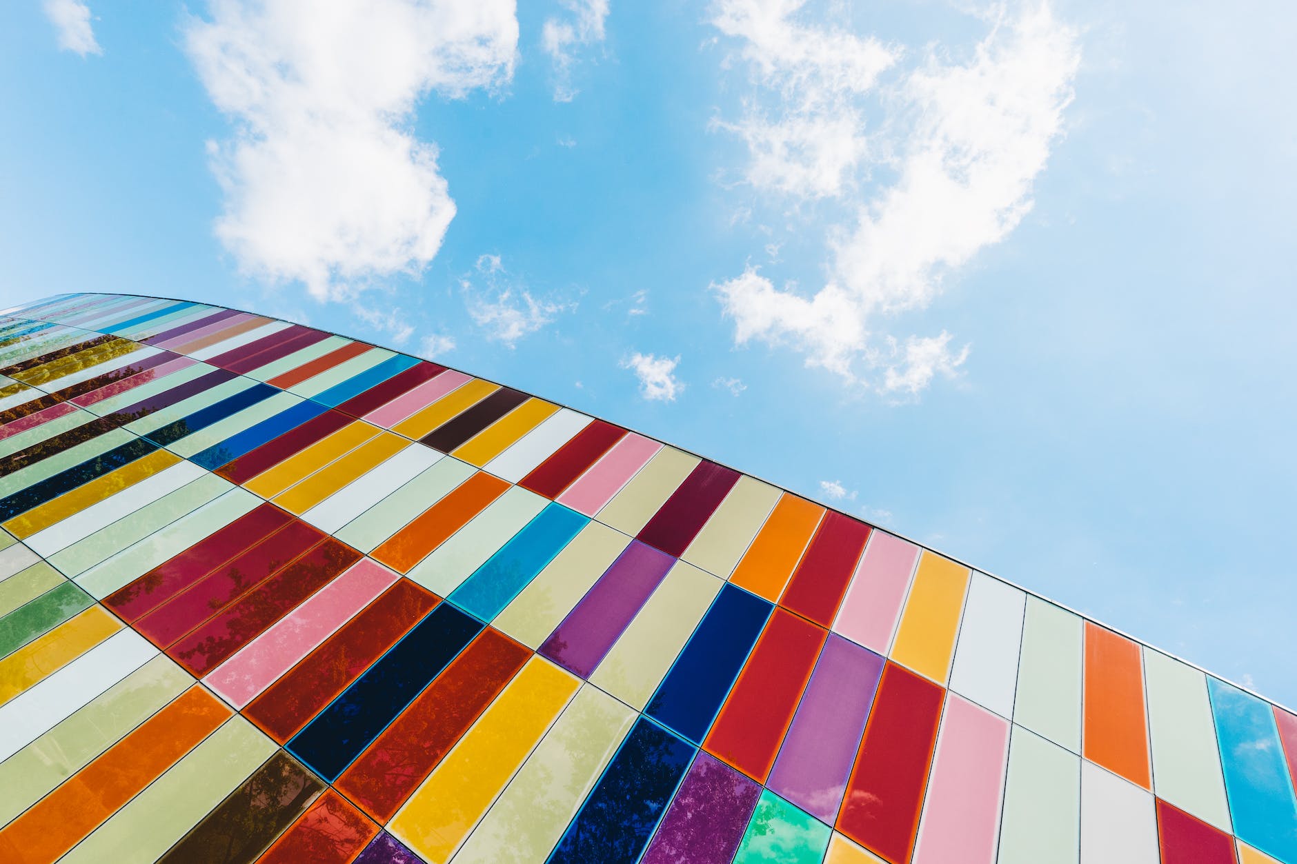 low angle of colorful glass panels under blue sky